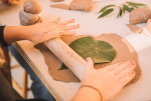 Rolling out a clay slab with a leaf imprint, Clay & Wine class, Nambour
