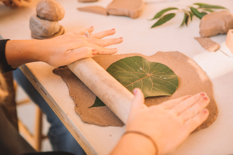 Rolling out a clay slab with a leaf imprint, Clay & Wine class, Nambour