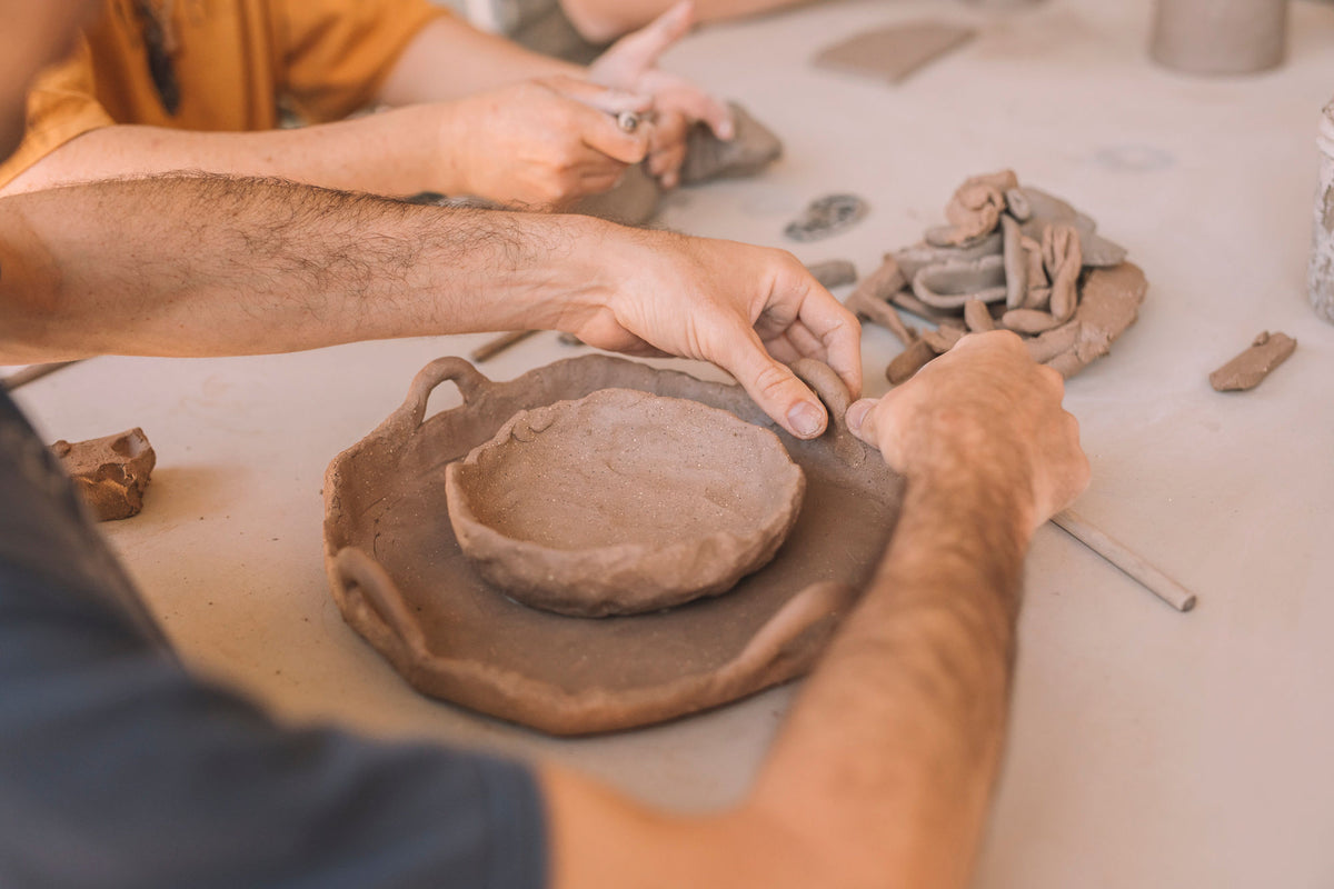 Student hand building pottery in a beginner course, Nambour