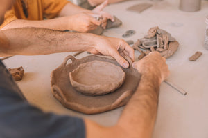 Student hand building pottery in a beginner course, Nambour