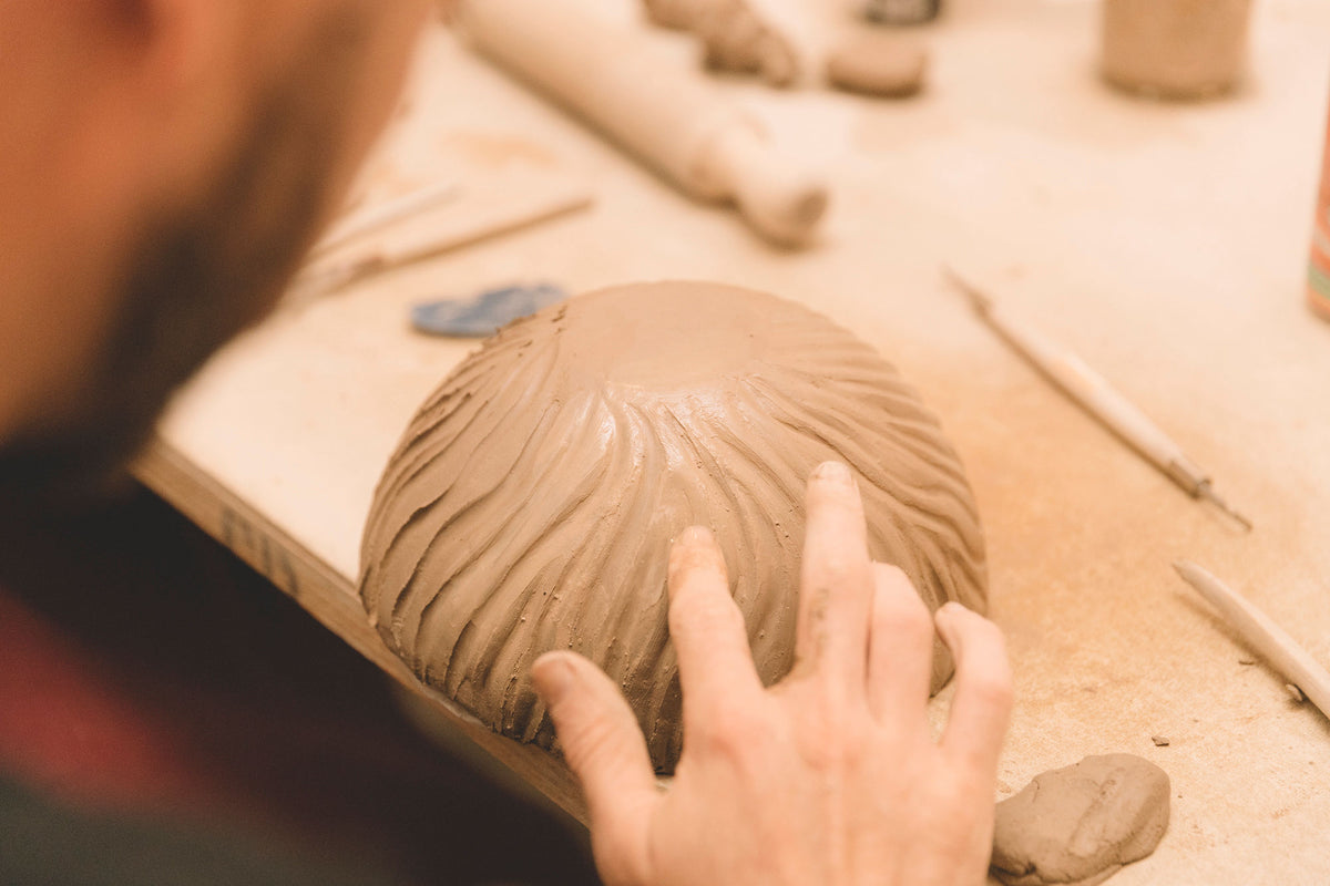 Student finishing a hand built piece, beginner course, Nambour