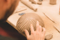 Student finishing a hand built piece, beginner course, Nambour