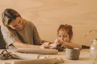 Young child and mum making pottery together, kids class, Nambour