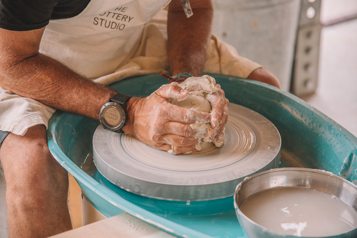 Centering clay on the pottery wheel, beginner wheel throwing course, Nambour
