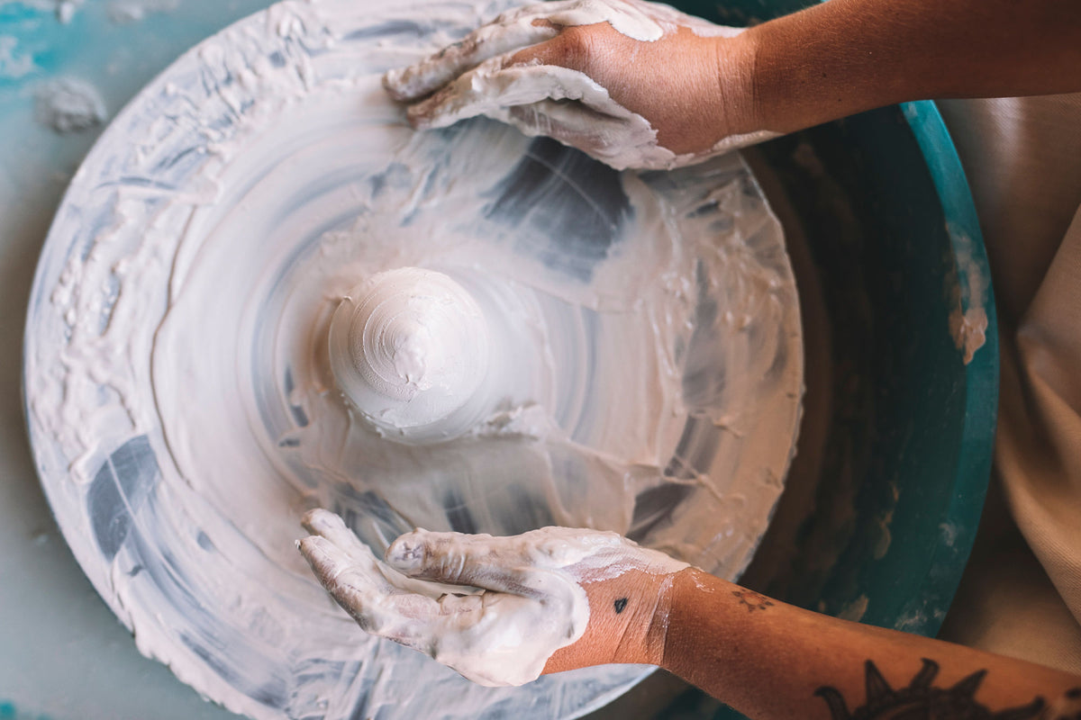 Clay centred on the pottery wheel, wheel throwing class, Nambour